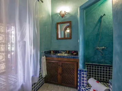 a bathroom with a sink and a mirror at Riad Samsli in Marrakech