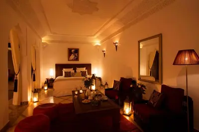 a living room with a bed and a table at Riad Dar Alfarah in Marrakech