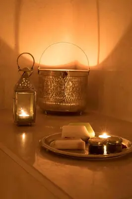 a table with a plate of cheese and a lantern at Riad Dar Alfarah in Marrakech