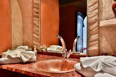 a bathroom counter with a sink and a mirror at Riad Aya in Marrakech