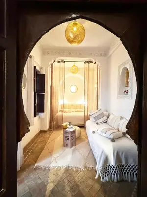 a room with a bed and a table in it at Riad Aya in Marrakech