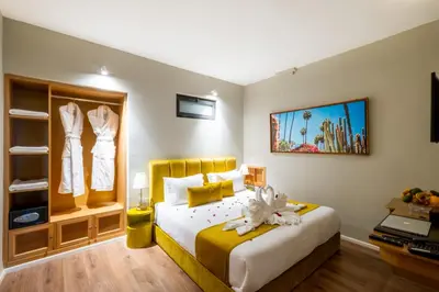 a bedroom with a large bed with a yellow headboard at Riad Mabrouk in Marrakech