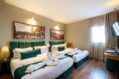 a hotel room with two beds with flowers on them at Riad Mabrouk in Marrakech