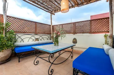 a patio with a table and a couch at Dar Picolina in Marrakech