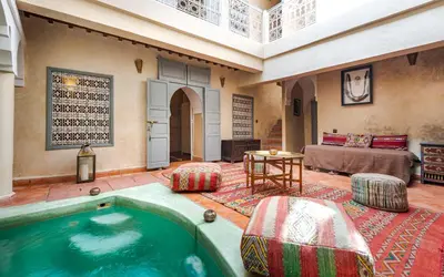 a large room with a swimming pool in a house at Dar Picolina in Marrakech