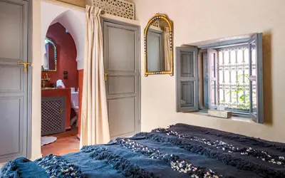 a bedroom with a bed and a window at Dar Picolina in Marrakech