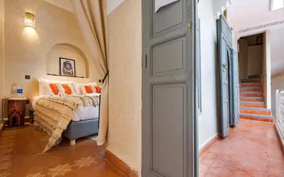 a bedroom with a bed and an open door at Dar Picolina in Marrakech