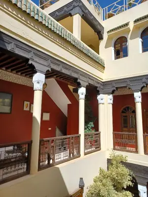 a large building with columns and balconies at Dar Taliwint in Marrakech