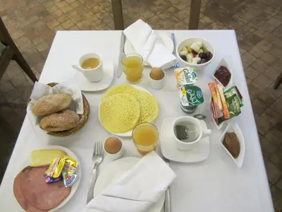 a white table with breakfast foods and drinks on it at Riad Amin in Marrakech