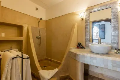 a bathroom with a sink and a shower at Riad Amin in Marrakech
