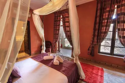 a bedroom with a bed with two towels on it at Riad Nabila in Marrakech