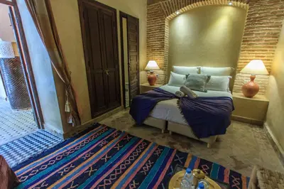 a bedroom with a bed and a large mirror at Riad Nabila in Marrakech