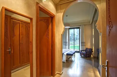 a hallway with a door to a room with a table at Villa de Luxe Domaine des Kasbahs in Marrakech