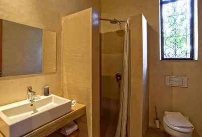 a bathroom with a sink and a shower at Villa de Luxe Domaine des Kasbahs in Marrakech