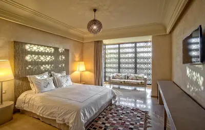 a bedroom with a bed and a large window at Villa de Luxe Domaine des Kasbahs in Marrakech