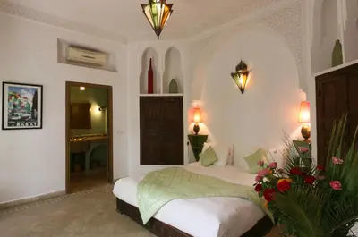a bedroom with a bed with flowers on it at Riad Pachavana in Marrakech