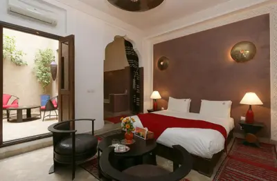 a hotel room with a bed and a table at Riad Pachavana in Marrakech