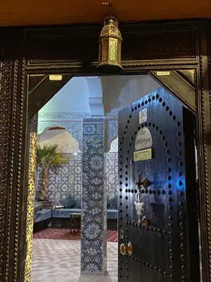 a door with a clock on top of it at Dar Dikrayat in Marrakech