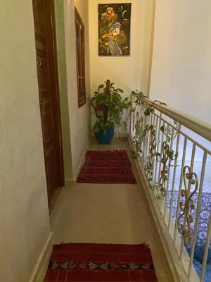 a hallway with a staircase with a potted plant at Dar Dikrayat in Marrakech