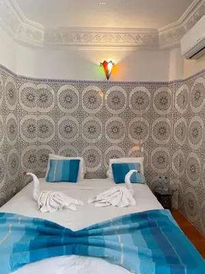 a bedroom with a bed with swans on it at Dar Dikrayat in Marrakech