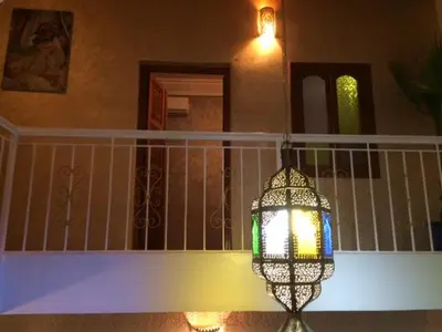 a chandelier is hanging on a balcony of a house at Dar Dikrayat in Marrakech