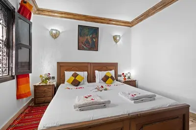 a bedroom with a large bed with towels on it at Riad Marwa Marrakech in Marrakech