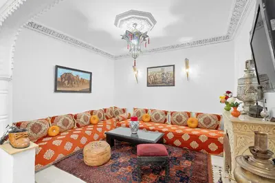 a living room with a couch and a table at Riad Marwa Marrakech in Marrakech