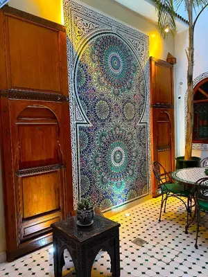 a wall with a large mandala painting on it at Riad La Perle Rouge in Marrakech