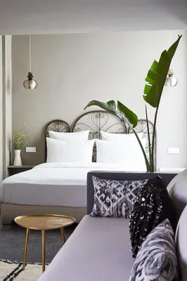 a bedroom with a large bed and a couch at Numa Marrakech in Marrakech