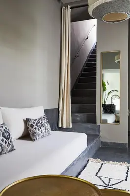 a bedroom with a bed and a staircase at Numa Marrakech in Marrakech