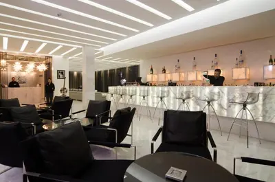 a bar with black chairs and a man taking a picture at Cesar Resort & Spa in Marrakech