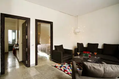 a living room with a couch and chairs and a bed at Cesar Resort & Spa in Marrakech