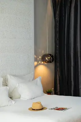 a hat is sitting on top of a bed at Cesar Resort & Spa in Marrakech