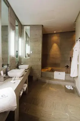 a bathroom with two sinks and a tub at Cesar Resort & Spa in Marrakech