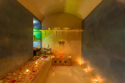 a room with a tub with candles on the floor at Riad Malika in Marrakech