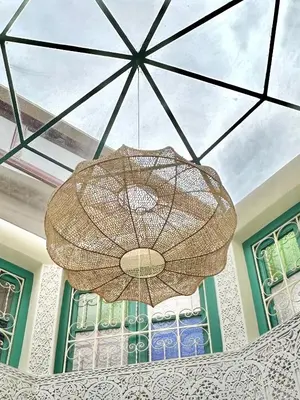 a large umbrella chandelier hanging from a ceiling at Riad Tasneem in Marrakech