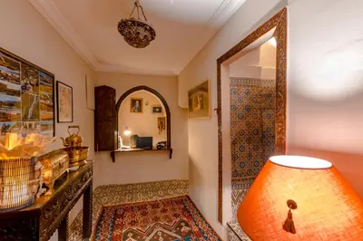 a room with a mirror and a table with a lamp at Abelia Riad - 2025 Guest Choice Award in Marrakech