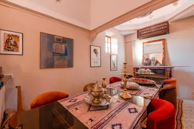 a dining room with a table and red chairs at Abelia Riad - 2025 Guest Choice Award in Marrakech