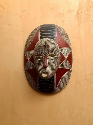 a clock with a cat face on a wall at Riad Bellamane Marrakech in Marrakech