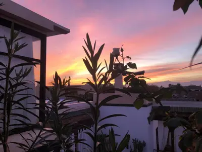 a view of a sunset from the balcony of a house at Riad Bellamane Marrakech in Marrakech