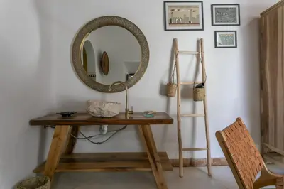 a dressing table with a mirror on a wall at Riad Safar in Marrakech