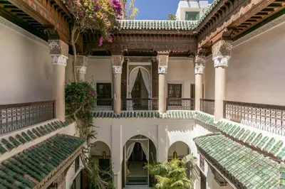 an indoor courtyard of a building with green tiles at Riad Safar in Marrakech