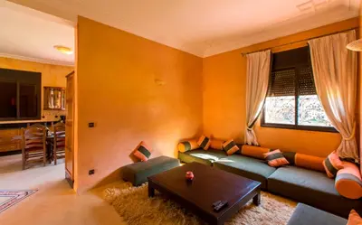 a living room with a couch and a table at Villa Zahra Palmeraie in Marrakech