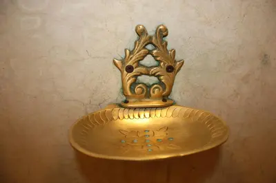 a gold vase with a crown on top of it at Riad Lorsya in Marrakech