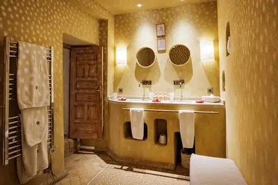 a bathroom with a sink and two mirrors at La Villa Nomade in Marrakech
