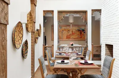 a dining room with a table and chairs at La Villa Nomade in Marrakech