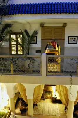 a view of a building with a balcony and a car at Riad Anjar in Marrakech