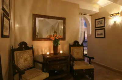 a room with two chairs and a table with a mirror at Riad Anjar in Marrakech