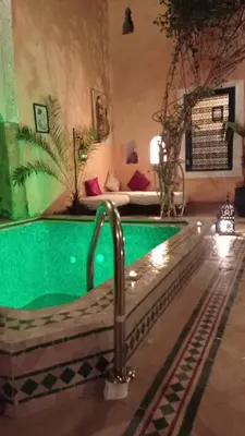 a pool in the middle of a room with a pool at Riad El Filali in Marrakech