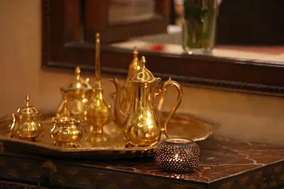 a group of gold tea sets on a tray at Riad Zayane in Marrakech